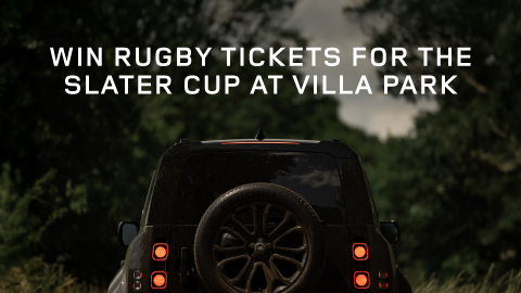 Rear of a Land Rover Defender vehicle in a forest with promotional white text overlay.