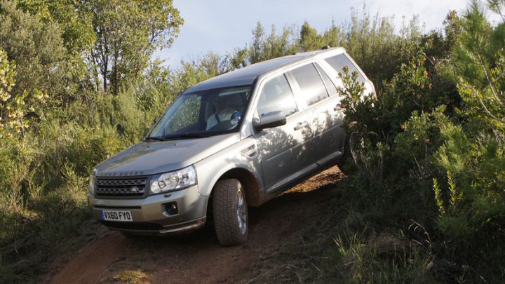 Silver Land Rover Freelander on a muddy road