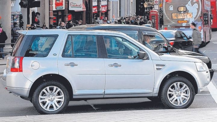White Land Rover Freelander parked at a traffic light in London