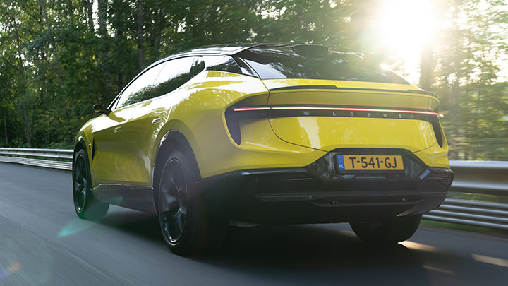Rear quarter shot of a parked yellow Lotus Eletre