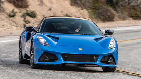 Driving shot of a blue Lotus Emira on a mountain road