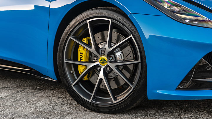 Close up of a blue Lotus Emira's alloy wheel and brakes