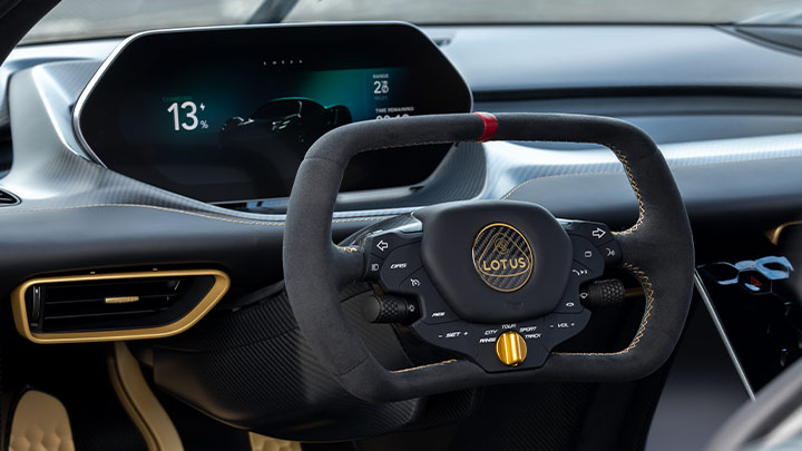 Close up of a Lotus Eviija's steering wheel and instrument cluster