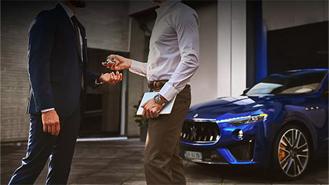 Close up of a service advisor handing keys over to a customer