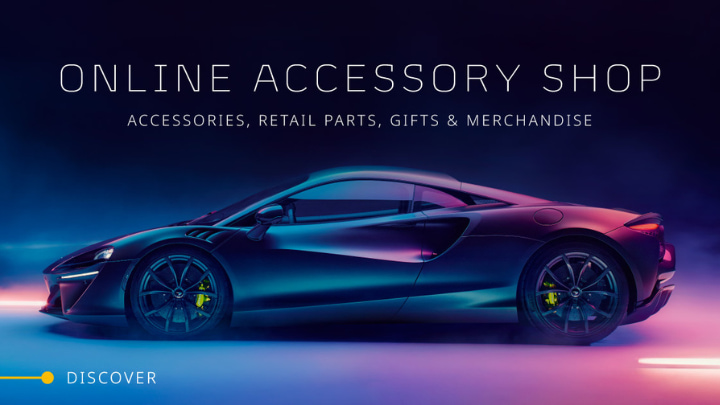 Black McLaren parked in a multi-coloured background