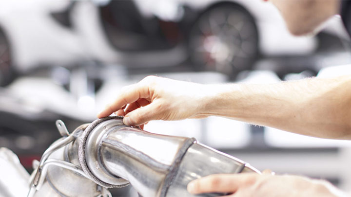 Technician Servicing a McLaren Exhaust