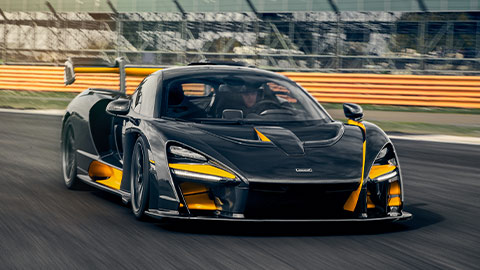 Black and Orange McLaren Senna Driving On Track