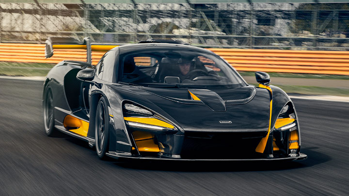 Black and Orange McLaren Senna Driving On Track