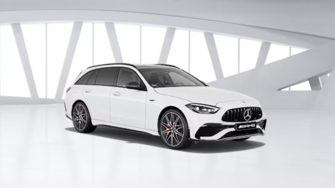 White Mercedes-Benz AMG C-Class Estate car in white warehouse background