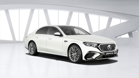 White Mercedes-Benz AMG E-Class Saloon car in white warehouse background