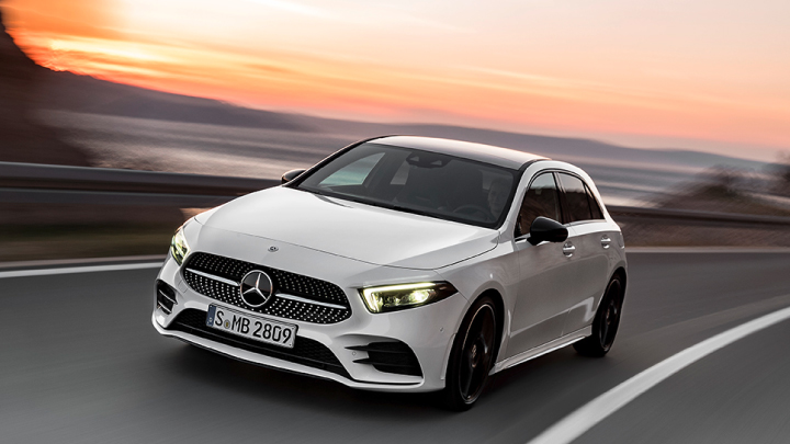White Mercedes-Benz A-Class driving on the road.
