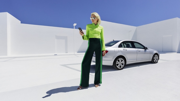 Woman in front of Mercedes-Benz Model using Mercedes-Benz App