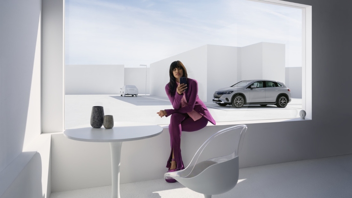 Woman in front of Mercedes-Benz Model using Mercedes-Benz App