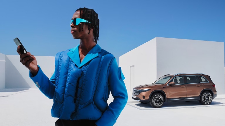 Man in front of Mercedes-Benz Model using Mercedes-Benz App