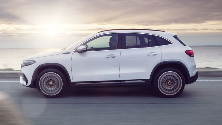 Side of a white Mercedes-Benz EQA driving by the ocean