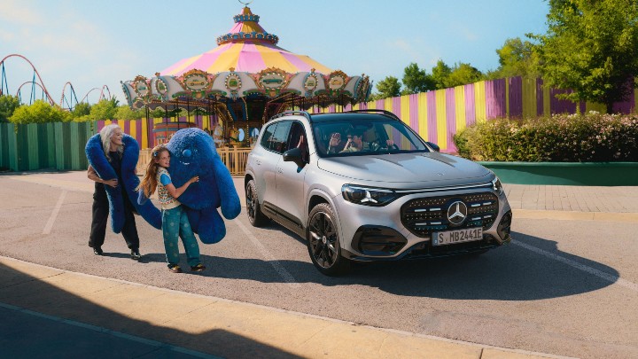 Silver Mercedes Benz GLB Electric outside with family at fairground