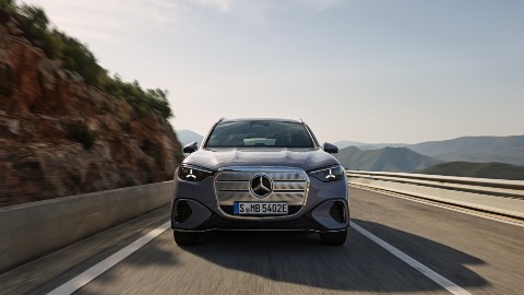 Grey Mercedes GLC Electric driving mountain road front angle