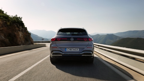 Grey Mercedes GLC Electric driving mountain road rear angle