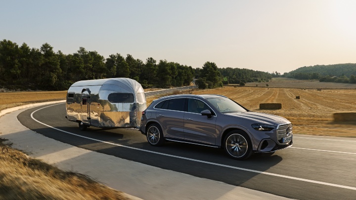 Grey Mercedes GLC Electric driving towing caravan