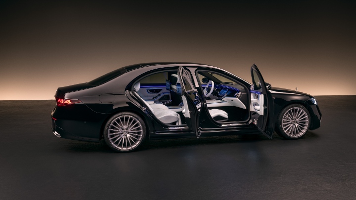 Black Mercedes-Benz S-Class dark background doors open white interior side angle