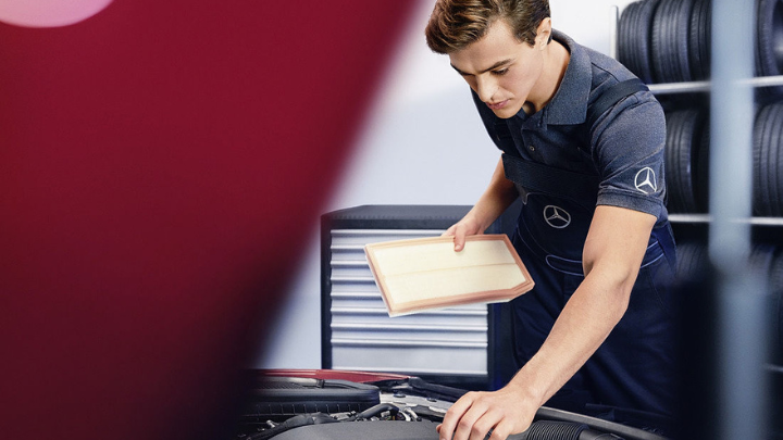 Workshop Colleague Working on Bonnet of Car