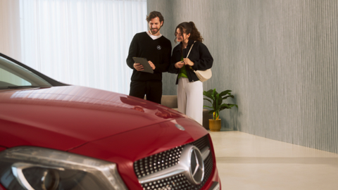 Two People Chatting With Red Mercedes-Benz In Foreground