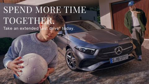 Father and Son Stood With a Silver Mercedes Vehicle