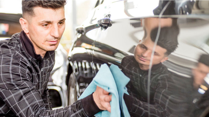 Technician Cleaning Car