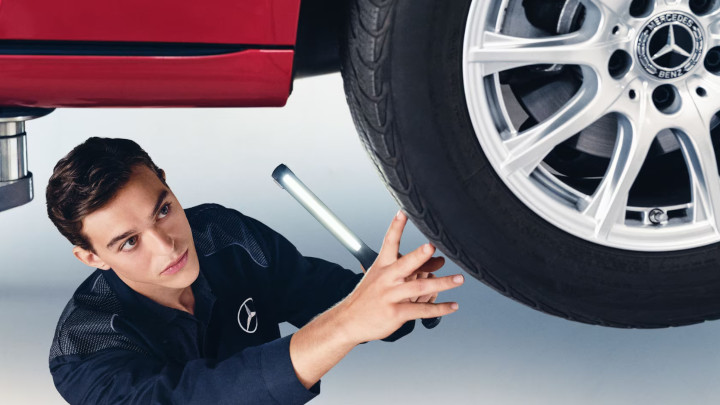 Technician Servicing Mercedes-Benz Car Wheel