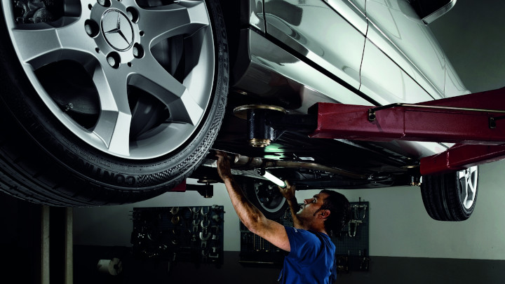 Technician Servicing Mercedes-Benz Car