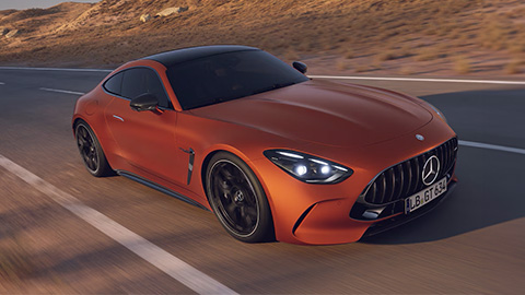 Orange Mercedes-Benz AMG-GT driving on the road