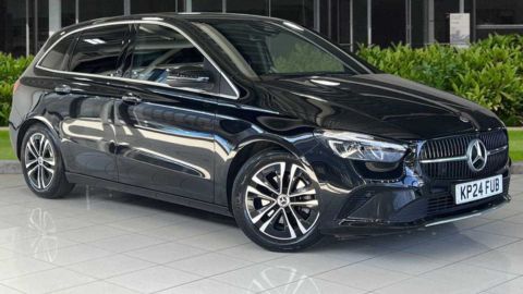 Black Mercedes-Benz B-Class parked in front of a dealership