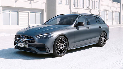Grey Mercedes-Benz C-Class parked in front of white houses