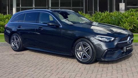 Black Mercedes-Benz C-Class parked in front of a dealership
