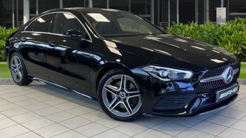Black Mercedes-Benz CLA parked in front of a dealership