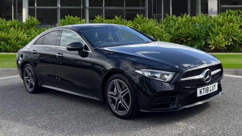 Black Mercedes-Benz CLS AMG Line parked in front of a retailer