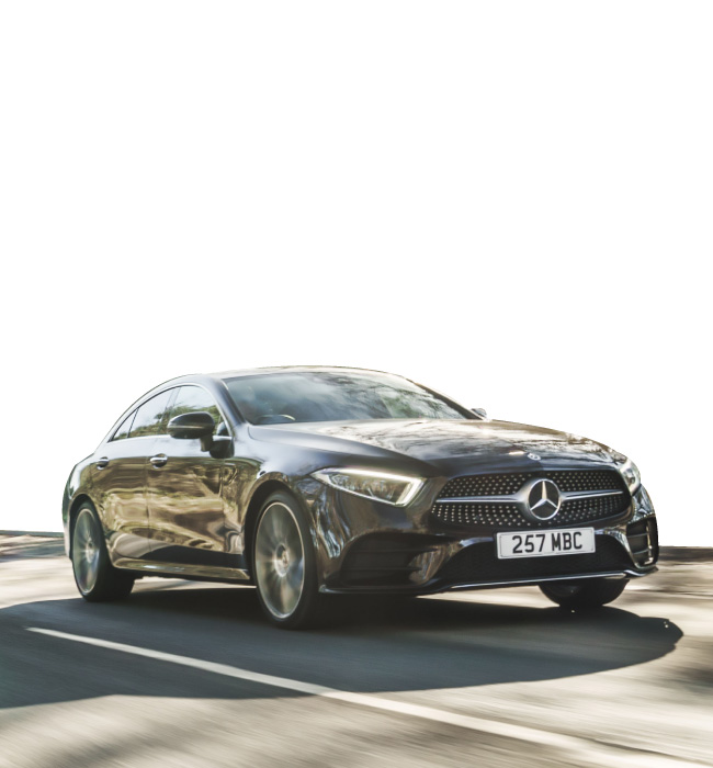 Black Mercedes-Benz CLS driving on the road