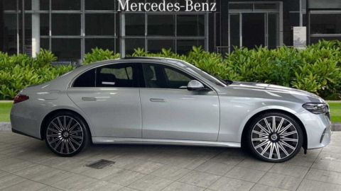 Silver Mercedes-Benz parked in front of a dealership