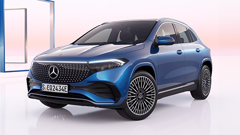 Blue Mercedes-Benz EQA parked in front of a white and pink background