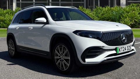 White Mercedes-Benz EQB parked in front the dealership