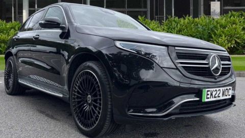 Black Mercedes-Benz EQC parked in front of the dealership