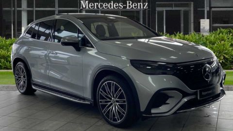 Silver Mercedes-Benz EQE parked in front of a dealership