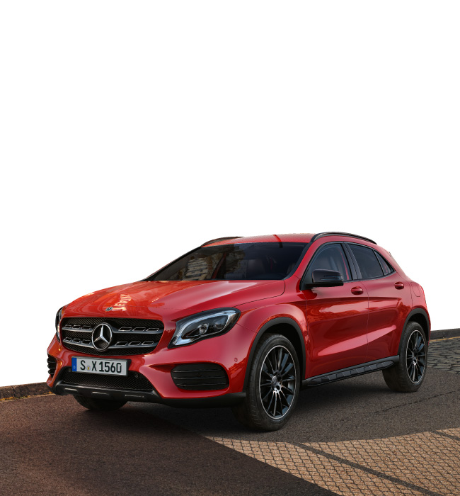 Red Mercedes-Benz GLA parked on a brown road