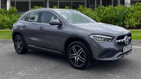 Grey Mercedes-Benz GLA parked in front of a dealership