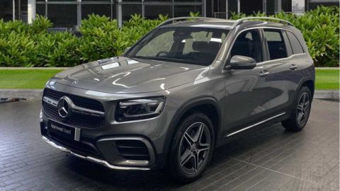 Silver Mercedes-Benz GLB parked in front of a dealership