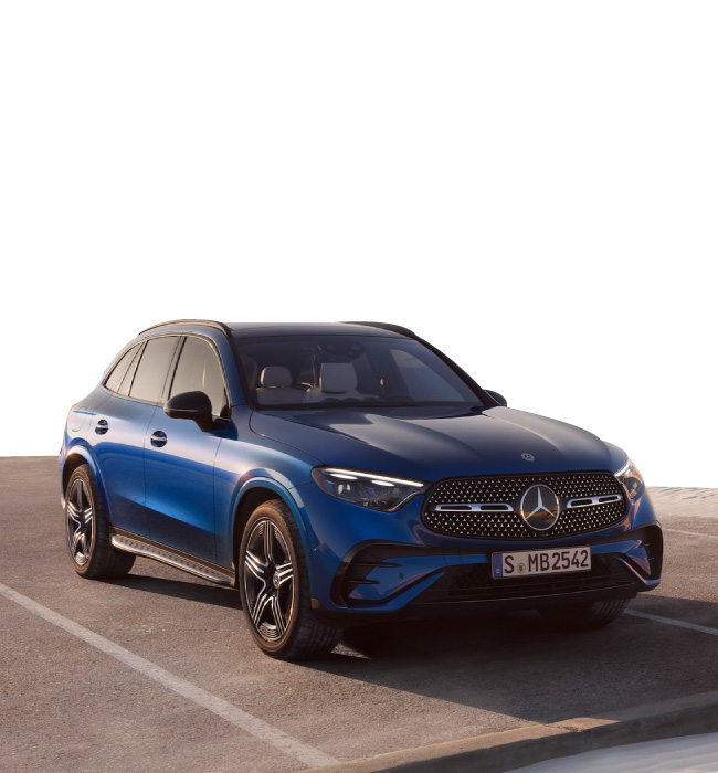 Blue Mercedes-Benz GLC parked in front of a white background