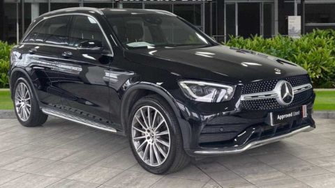 Black Mercedes-Benz GLC parked in front of a dealership