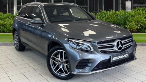 Grey Mercedes-Benz GLC AMG Line Premium parked in front of a dealership