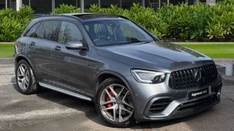 Grey Mercedes-Benz GLC AMG Line Premium Plus parked in front of a dealership