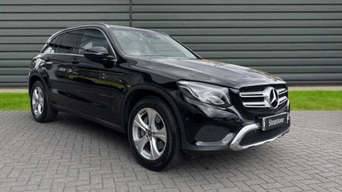 Black Mercedes-Benz GLC Sport parked in front of a dealership